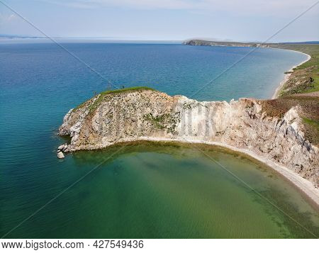 The Shore Of Lake Baikal From The Air. Beautiful Landscape Of Olkhon Island On A Summer Day. Cape Ha