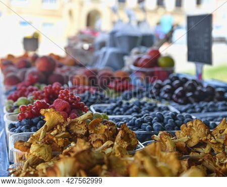 Chanterelles Or Girolle Mushrooms And Other Fruit And Vegetables For Sale At Local Farmers Market. F