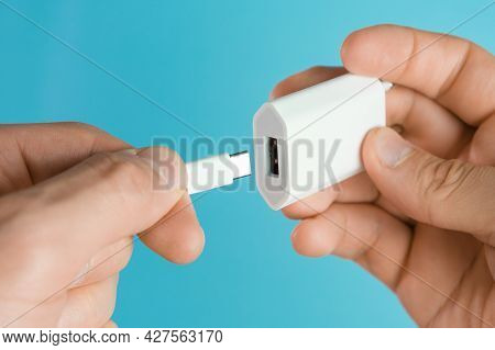 Usb Type C Cable And Usb Type A Adapter Plug In Mans Hands On The Blue Background