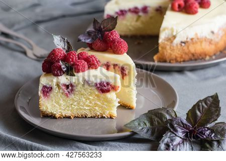 Raspberry Cheesecake Slices With Fresh Raspberries And Bazil Leaves On A Grey Plate, Whole Cheesecak