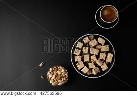 Halva With Pistachios Served With Coffee On Black. Traditional Middle Eastern Sweets. Jewish, turkis