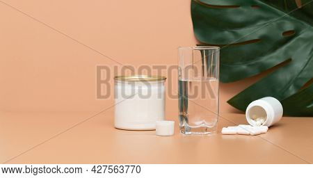Collagen On A Beige Background. Banner. Collagen Protein Powder And Tablets. Natural Plant Or Fish B