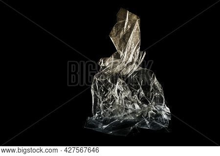 Plastic Foil From A Disposable Bag Shown Like An Art Sculpture Against A Black Background, Packaging