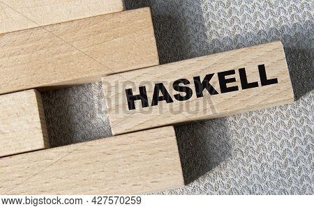 The Haskell Programming Language. Haskell Code On Wooden Blocks. Internet Concept