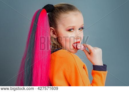 Kid Eats Tasty Macaroon Cookies. Traditional French Colorful Macaroons. Sweet Meringue-based Confect