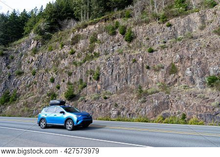 Road Trip In Car Along Mountain Wall In Oregon, Usa