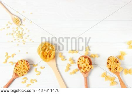 Different Types Of Pasta Close-up On A Colored Background.