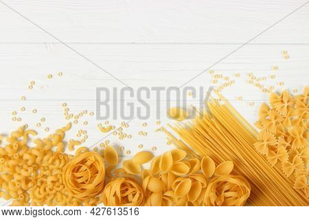 Different Types Of Pasta Close-up On A Colored Background.