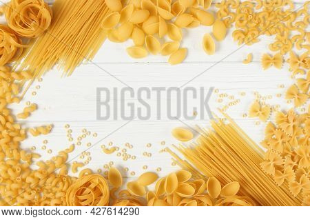 Different Types Of Raw Pasta Close-up On A Colored Background.