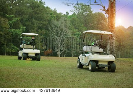Golfcar In Beautiful Golf Course In The Evening Golf Course With Sunshine In Thailand