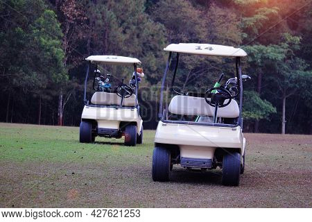 Golfcar In Beautiful Golf Course In The Evening Golf Course With Sunshine In Thailand