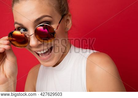 Charming Positive Amazed Happy Young Blonde Woman Isolated Over Red Background Wall Wearing Casual W