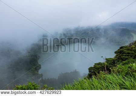 Deep lake in Flores Island, Azores Archipelago, Portugal. Green lagoon with green vegetation