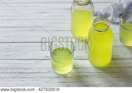 Healthy Dietary Milk Whey In Glass And Bottle On Light Blue Table, Space