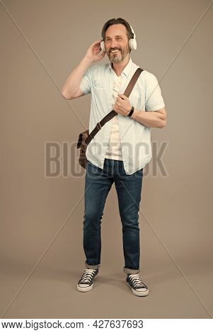Cool Choice For Audiophile. Cool Man Listen To Music On Foot. Happy Adult Wear Headphones While Trav