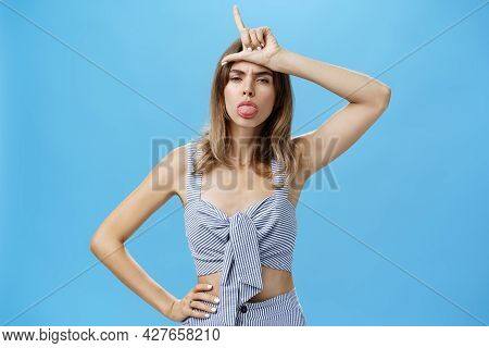 Waist-up Shot Of Stylish Self-assured Woman With Tattoo Feeling Like Winner Mocking Over Losers Stic