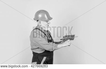 He Needs Little Break. Plasterer In Working Uniform Plastering. Man With Spatula. Process Of Applyin