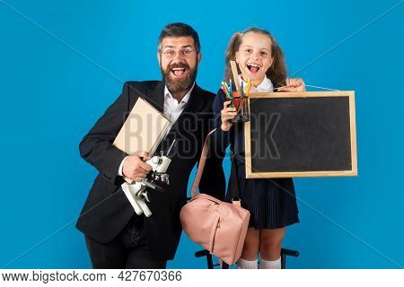 Funny Little Schoolgirl In School Uniform Having Fun In Studio. Portrait Of Amazed Excited Happy Pup