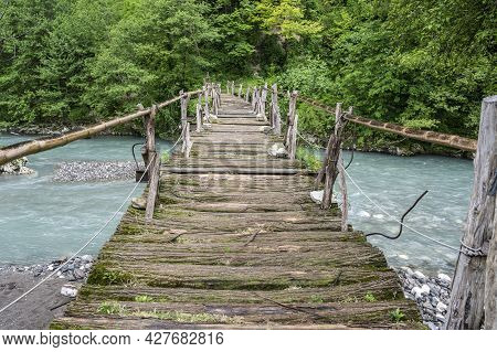 An Old Wooden Bridge Over The Western Gumista River In The Republic Of Abkhazia. Cloudy Day May 17, 
