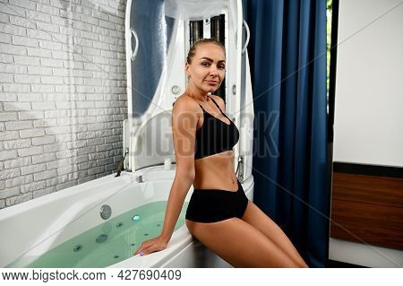 Attractive Young Woman Getting Ready For Spa Beauty Treatment In Spa Capsule. Hydro And Vibromassage
