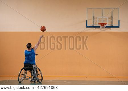 a photo of a war veteran playing basketball with a team in a modern sports arena. The concept of sport for people with disabilities