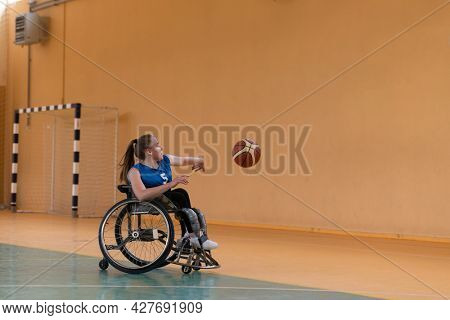 a young woman playing wheelchair basketball in a professional team. Gender equality, the concept of sports with disabilities. 