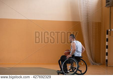 a photo of a war veteran playing basketball with a team in a modern sports arena. The concept of sport for people with disabilities