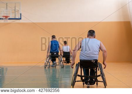 photo of wheelchairs and handicapped war veterans playing basketball on the court