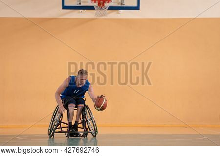 disabled war veterans in action while playing basketball on a basketball court with professional sports equipment for the disabled