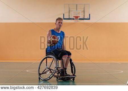 disabled war veterans in action while playing basketball on a basketball court with professional sports equipment for the disabled