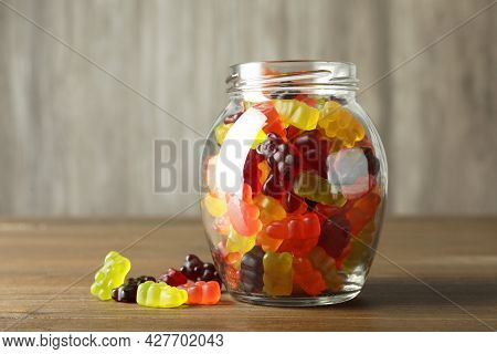 Delicious Gummy Bear Candies In Jar On Wooden Table