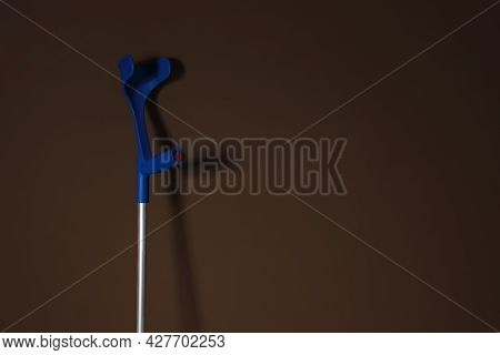 Elbow Crutch On Brown Background. Space For Text
