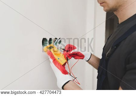 Electrician Measuring Voltage 2. High Quality Beautiful Photo Concept