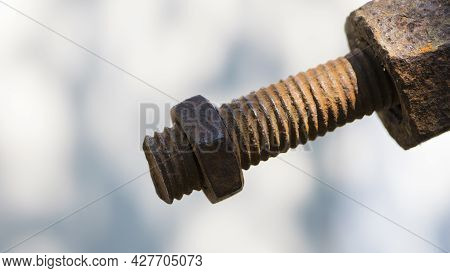 Old Rusty Bolt, Iron Rod With Screw Threads. Rusted Mechanical Components. Threaded Bolt And Nut Iso