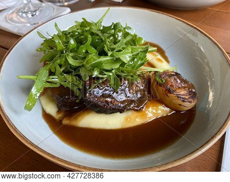 Braised Veal Cheeks With Puree Sauce And Salad Served In Fine Dining Restaurant. Ready To Serve And 