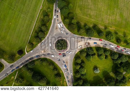 Aerial View Of A Busy Countryside Road Roundabout At Rush Hour With Traffic Queueing