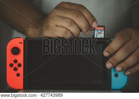 Samut Prakan, Thailand - July 24, 2021 : Close Up Of Man Inserting The Legend Of Zelda: Skyward Swor