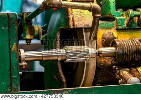 Grinding The Shaft Journal For The Bearing On The Pinion Shaft On A Cylindrical Grinder.