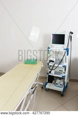 Medical Equipment For Video Gastroscopy In The Room. A Patients Couch And A Stand With A Gastroscope