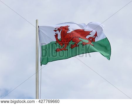 Wales Flag - Red Dragon Passant On White And Green - Bold And Proud Floating In The Wind Against Clo