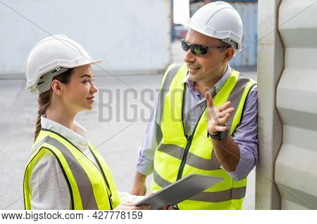 Caucasian Men And Women Freight  Supervisor Wearing Safety Vest And Hat While Inspect Condition Of A