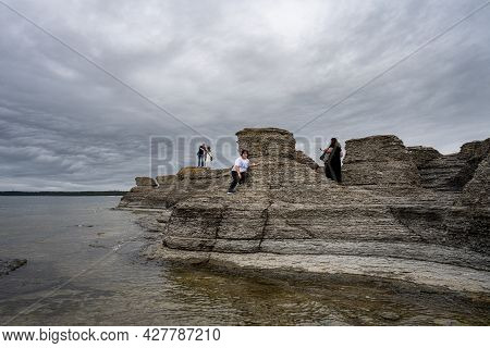 June 6, 2021 - Borgholm, Sweden: People Enjoy Beautiful Limestone Formations With A Dramatic Sky In 