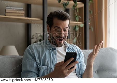 Man Holds Cellphone Gawp At Screen Read News Feels Surprised