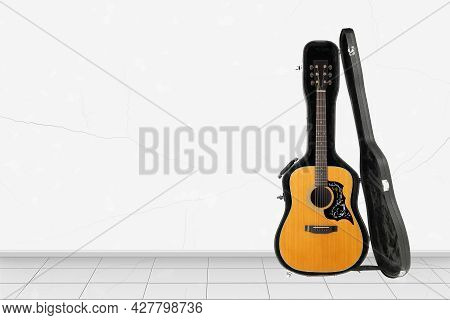 Home Interior -  Front View Acoustic Guitar Open Hard Case Of White Wall Background