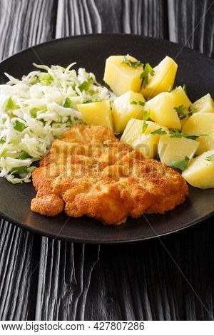 Kotlet Schabowy Polish Breaded Pork Chop With Boiled Potatoes And Cabbage Salad Close-up In A Plate 