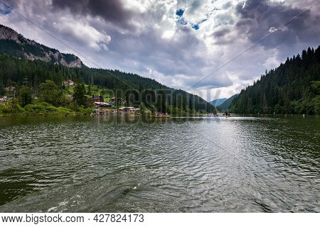 Lacu Rosu, Romania- 25 July 2021: People Spending The Summer Holiday Boating On The Unique Lake.