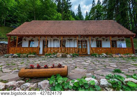 Lacu Rosu, Romania- 25 July 2021: Traditional Hungarian Wooden Guest House Near Roadside.