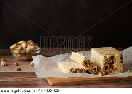 Organic Halva With Pistachios On A Wooden Surface. Traditional Middle Eastern Sweets. Jewish, Turkis