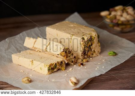Organic Halva With Pistachios On A Wooden Surface. Traditional Middle Eastern Sweets. Jewish, Turkis