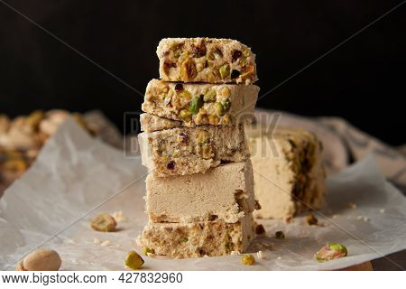 Organic Halva With Pistachios On A Wooden Surface. Traditional Middle Eastern Sweets. Jewish, Turkis